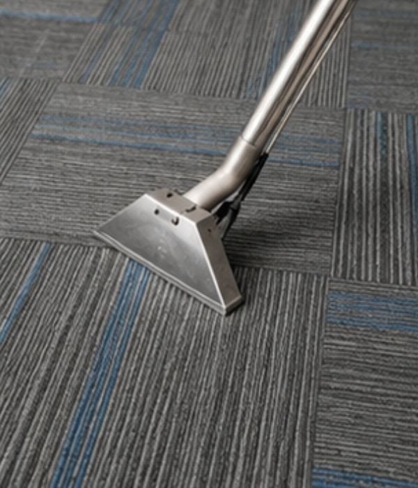 Commercial carpet cleaning machine on a patterned carpet floor.