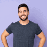 Happy man with clean carpet after professional cleaning service.